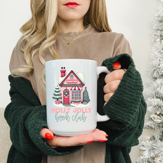 Person holding a mug with a Christmas book design in front of a decorated tree.